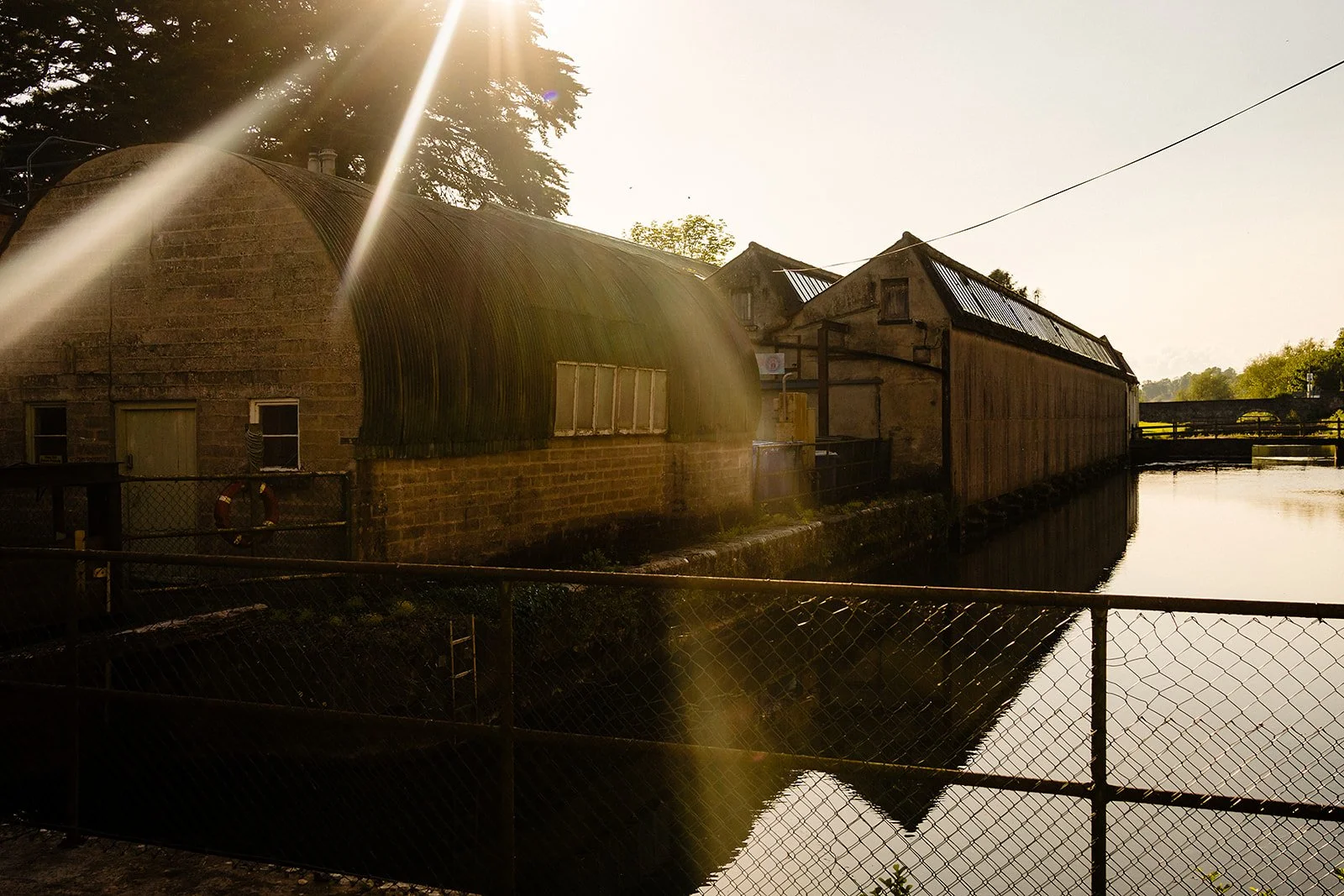 sun flare coming in over the river in the millhouse by the bridge