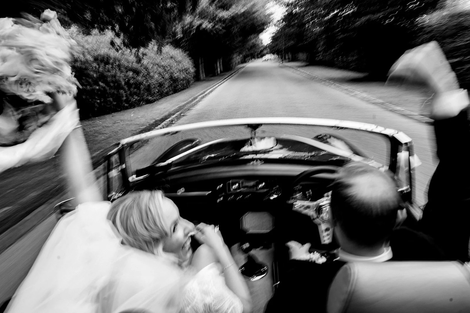 couple arriving to cliff at lyons in an open top car.