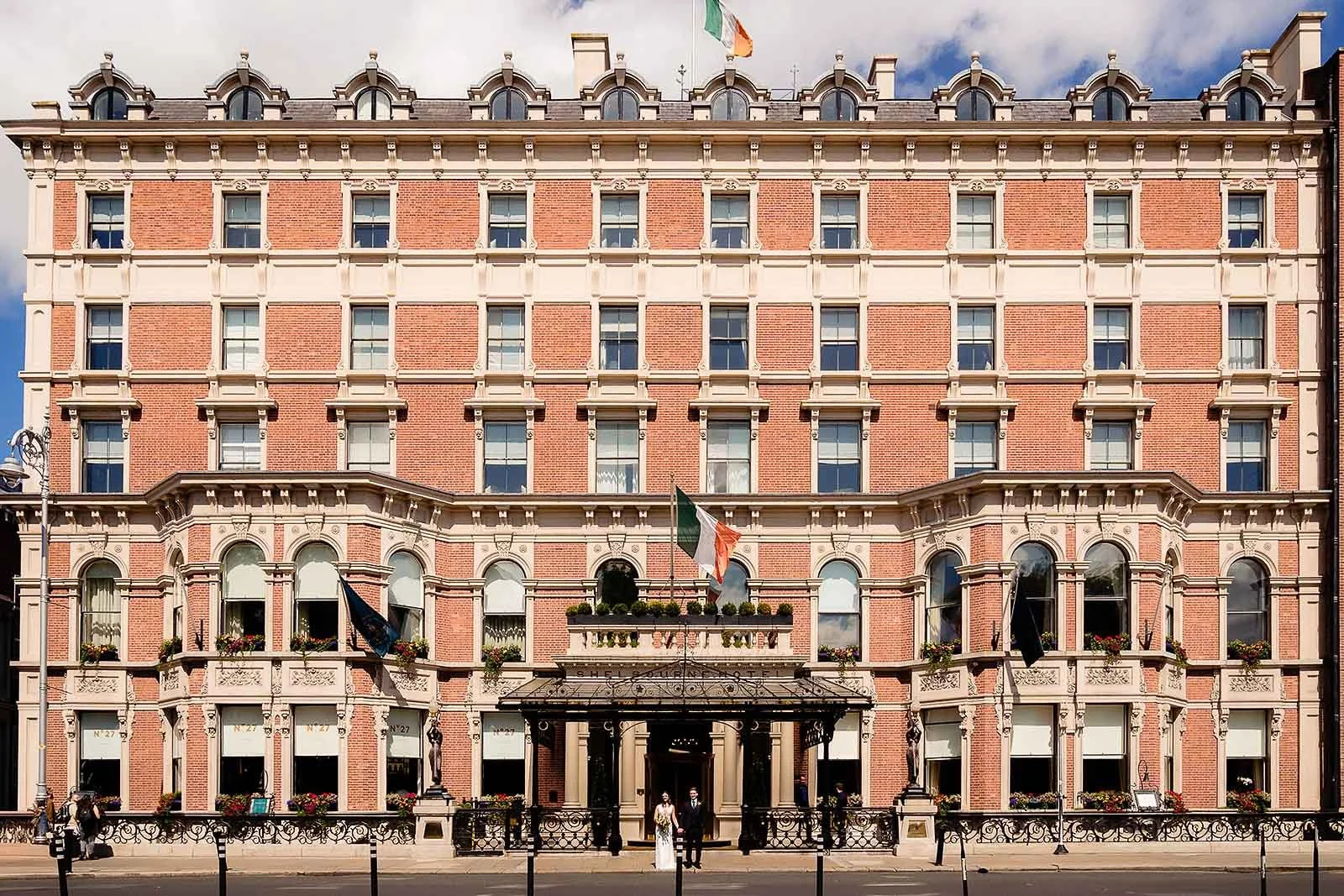 Shelbourne Hotel, wedding photography - Wes anderson style image of couple standing outside the hotel.