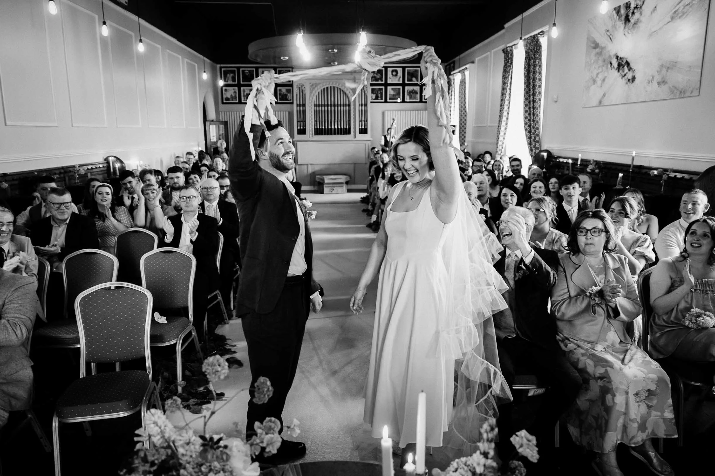 Wedding photo of couple in ceremony hand fastening in orlagh house