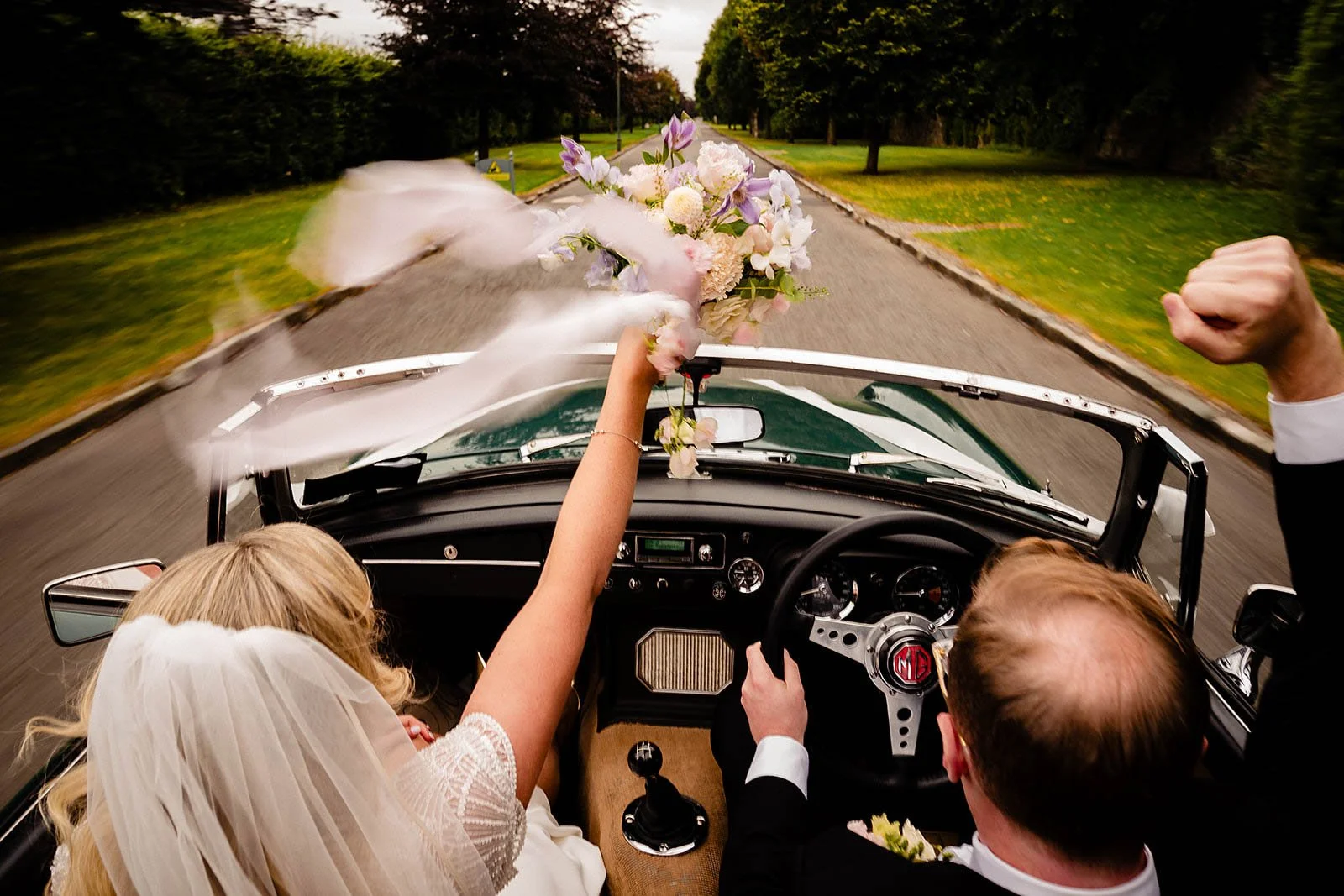 Cliff at Lyons wedding photographer – open top car arriving up the driveway at Cliff at Lyons Kildare