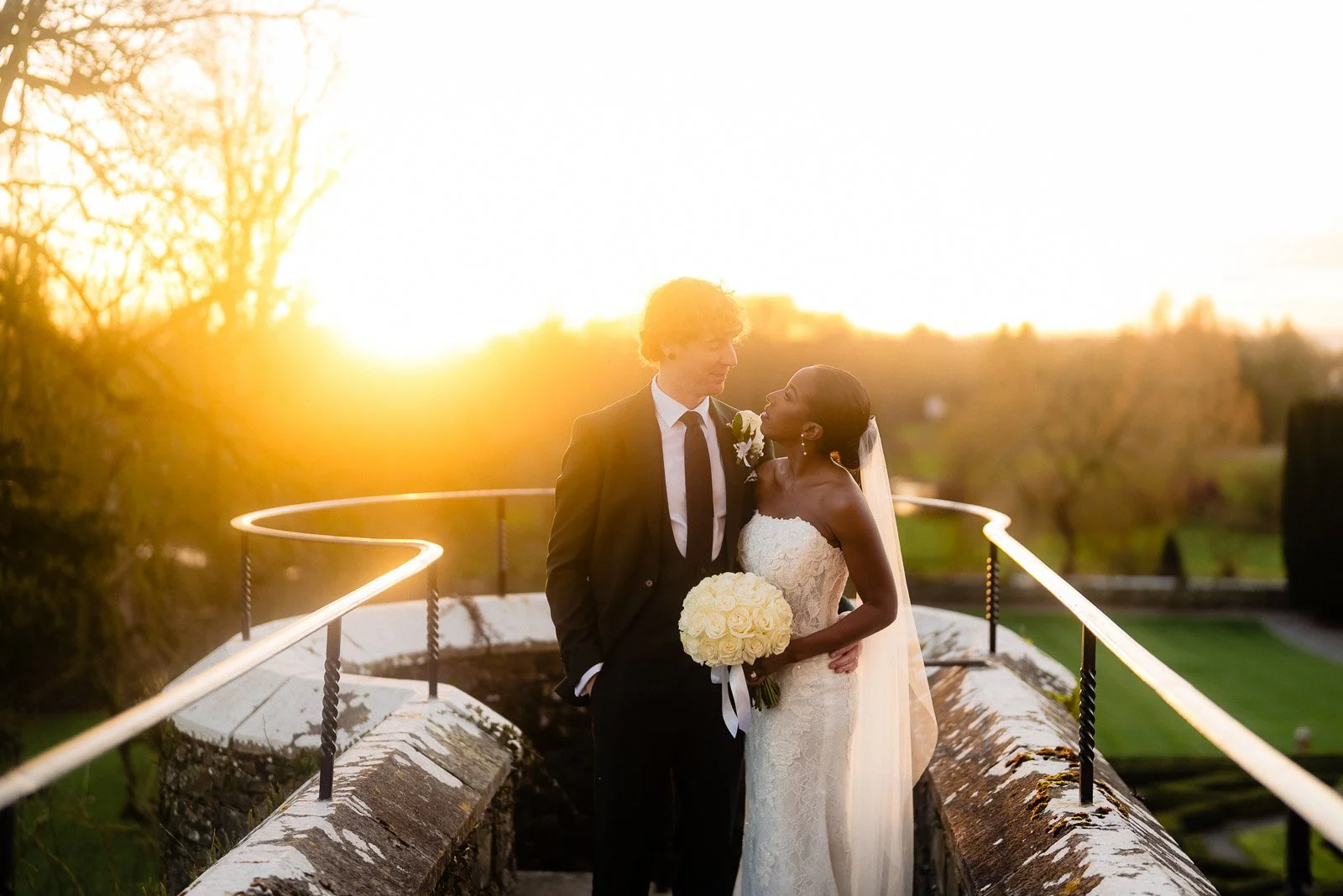 golden hour photo of a wedding couple kissing in golden light