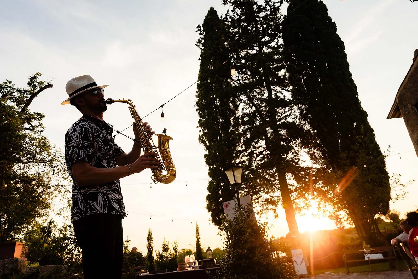 sax player in sunset at a brogo di tragliata wedding
