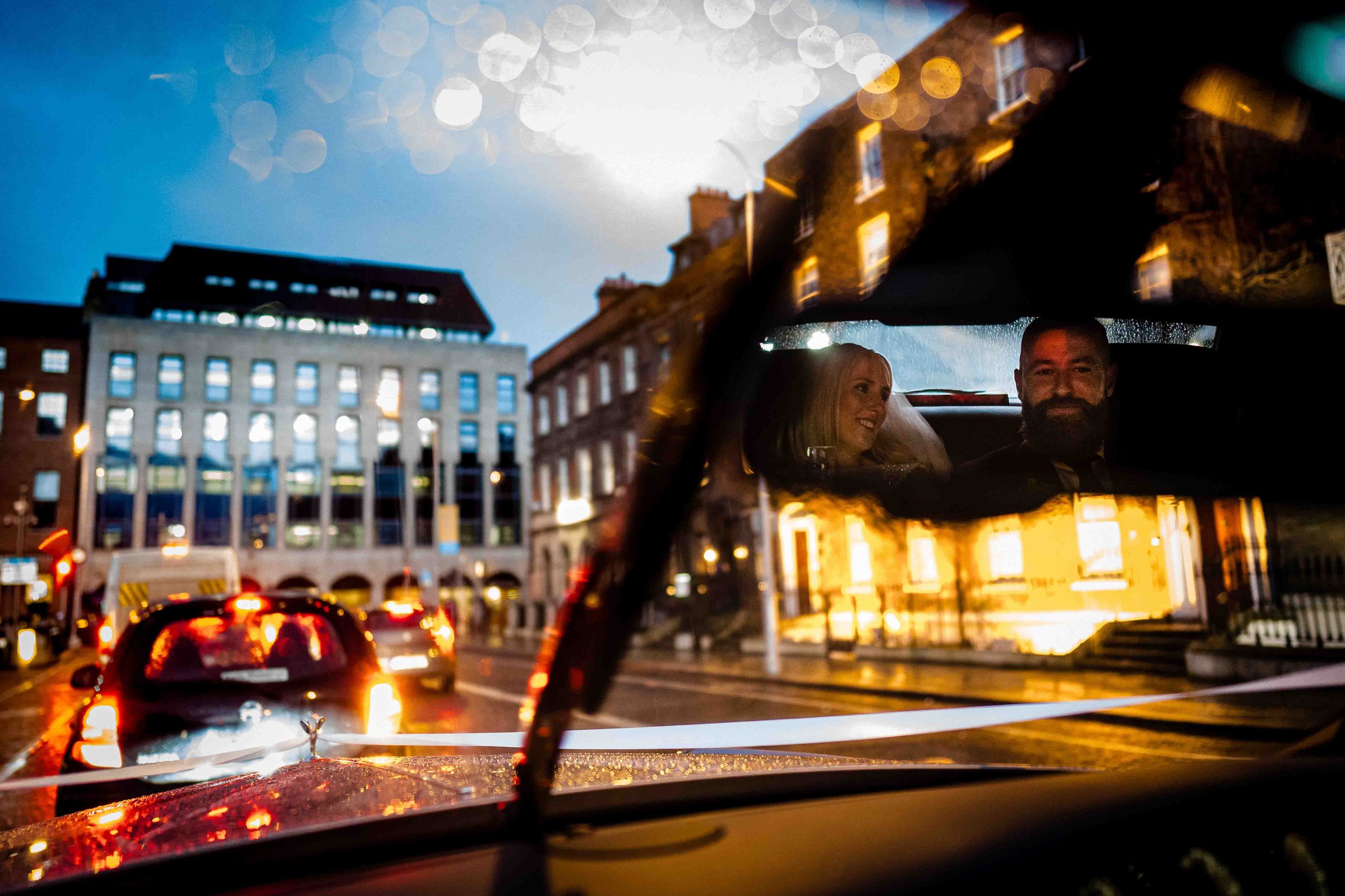 married couple in a car driving through dublin city