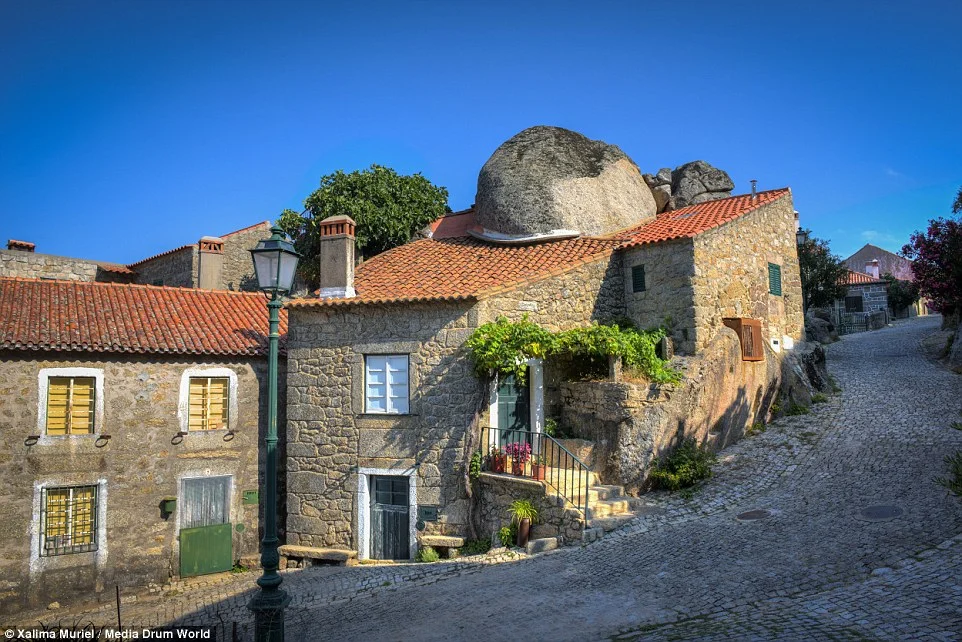 Villagers have formed their homes around the existing rocks, rather than attempt to move them