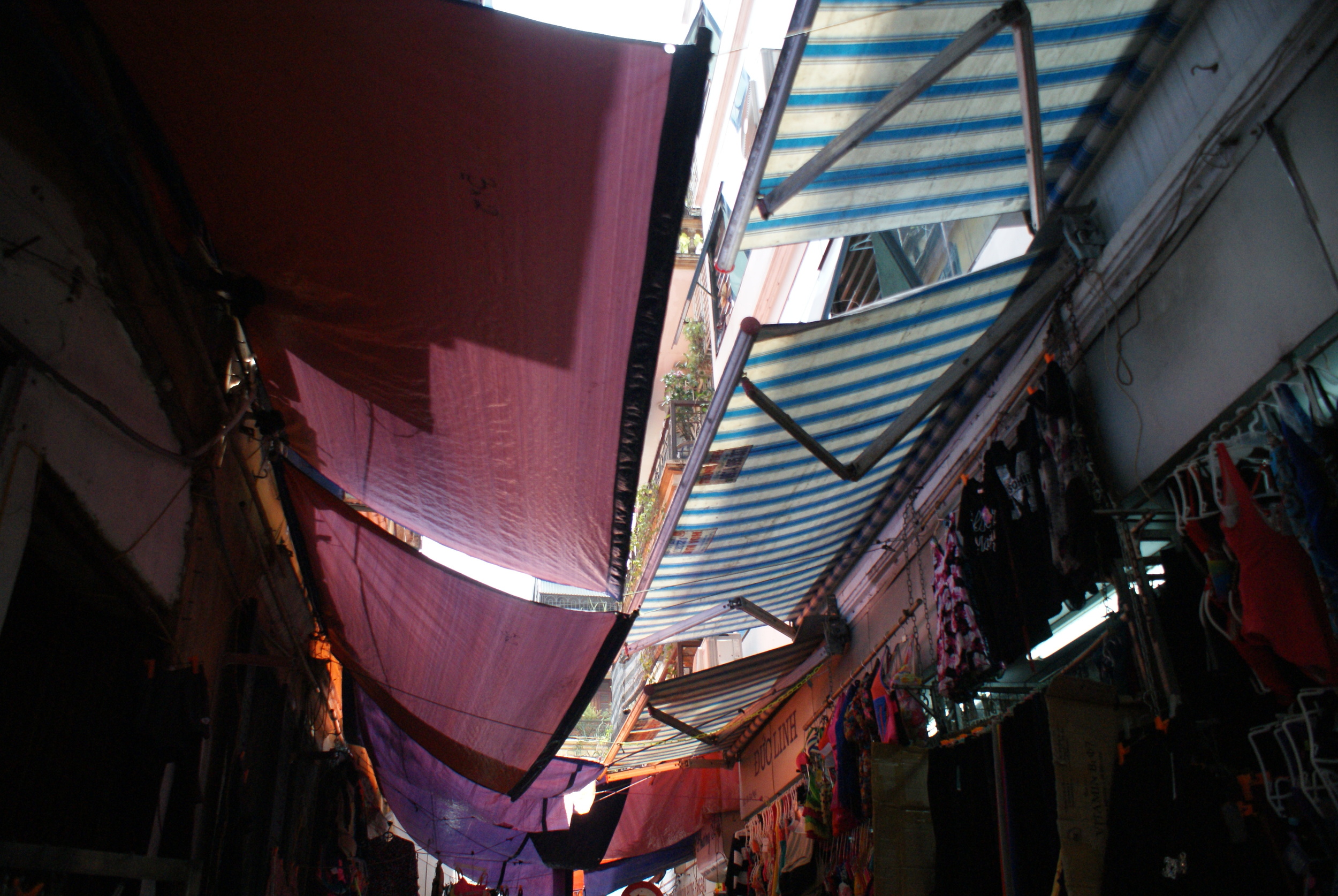 Cloth awnings keep street dwellers away from the hot sun. 