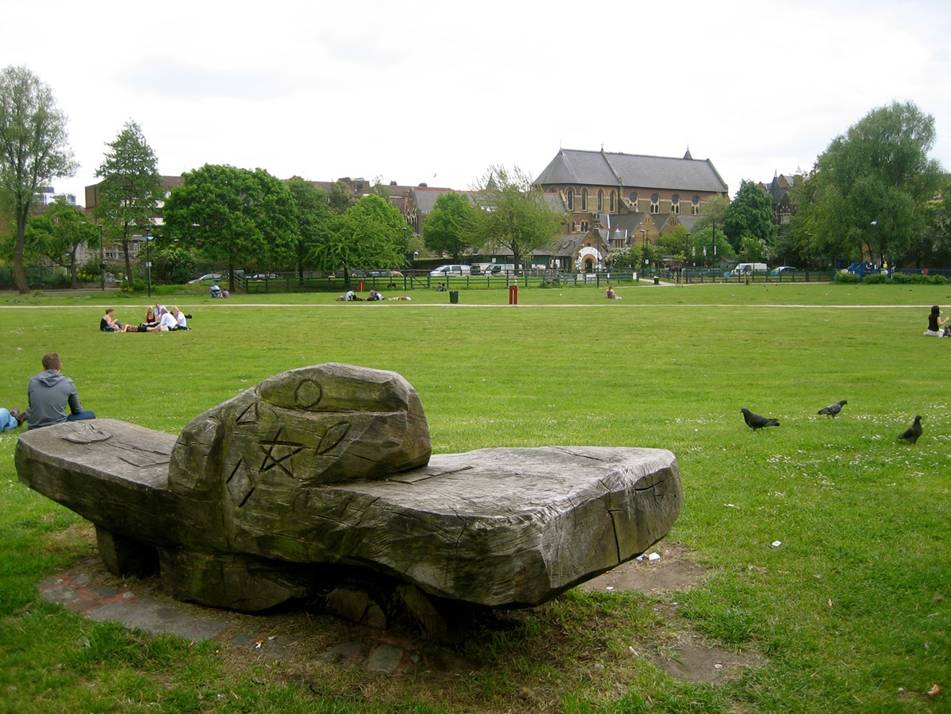 The main lawn overlooking Vauxhall City Farm with Friedel Buecking's Sculpted bench in the foreground