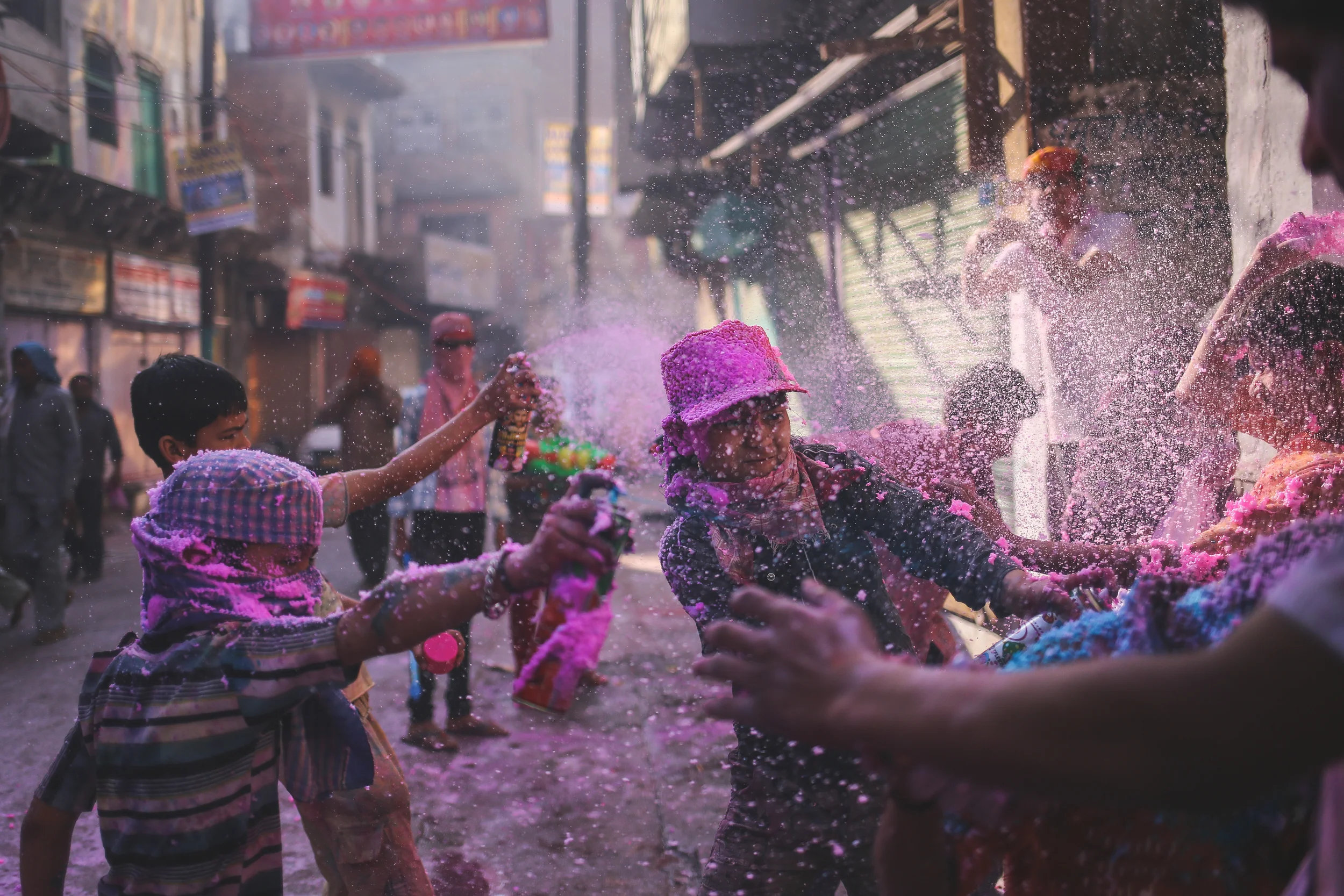 Mathura, India - March 24 th, 2016: Kids gang up on one of their friends during Holi festivities.