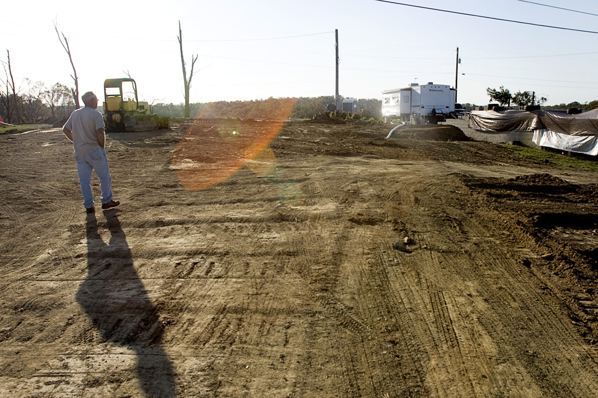 Leonard Barber walks across the vacant lot where his home of 42 years stood.