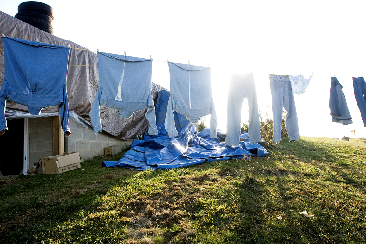 Clothes blow in the wind as Shirley does laundry outside.