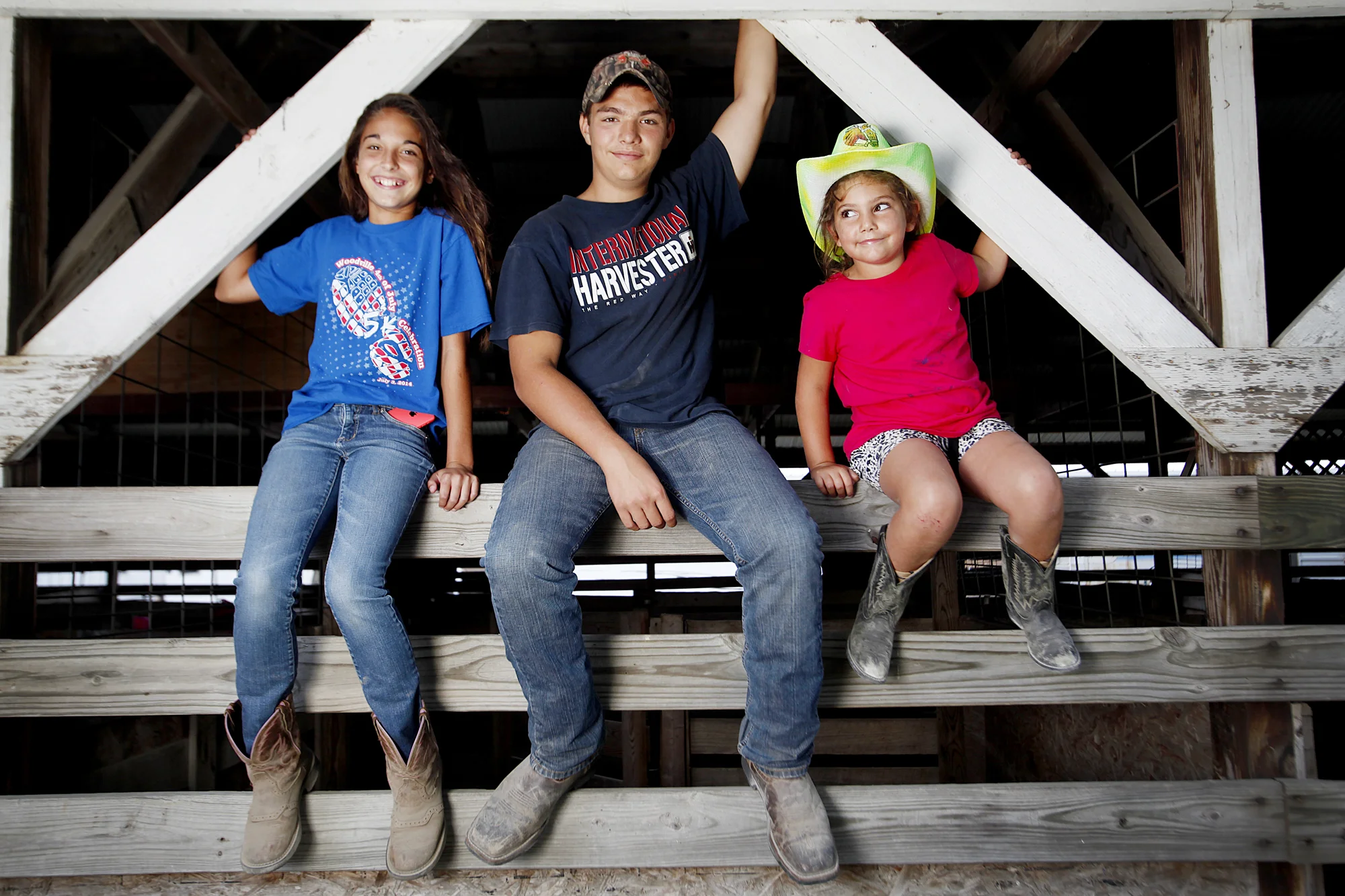  From left, Lizzy Cook, 12, of Woodville, Tyler Meeker, 14, of Genoa, and Natalia Wagner, 6, of Oak Harbor, at the horse stables during the Ottawa County Fair on July 16, 2014. 
