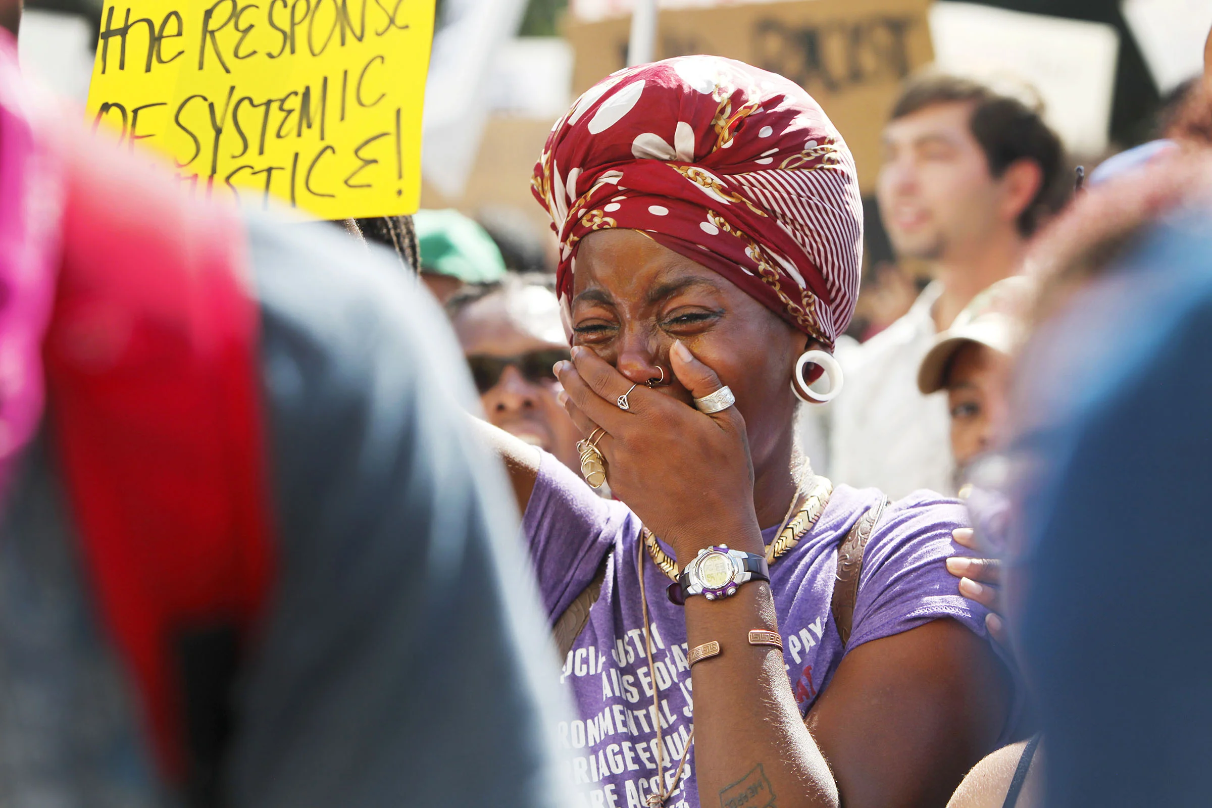  Debbie Long is overcome with emotion as she and fellow protestors stop at the Charlotte-Mecklenburg Police Station September 24, 2016. 