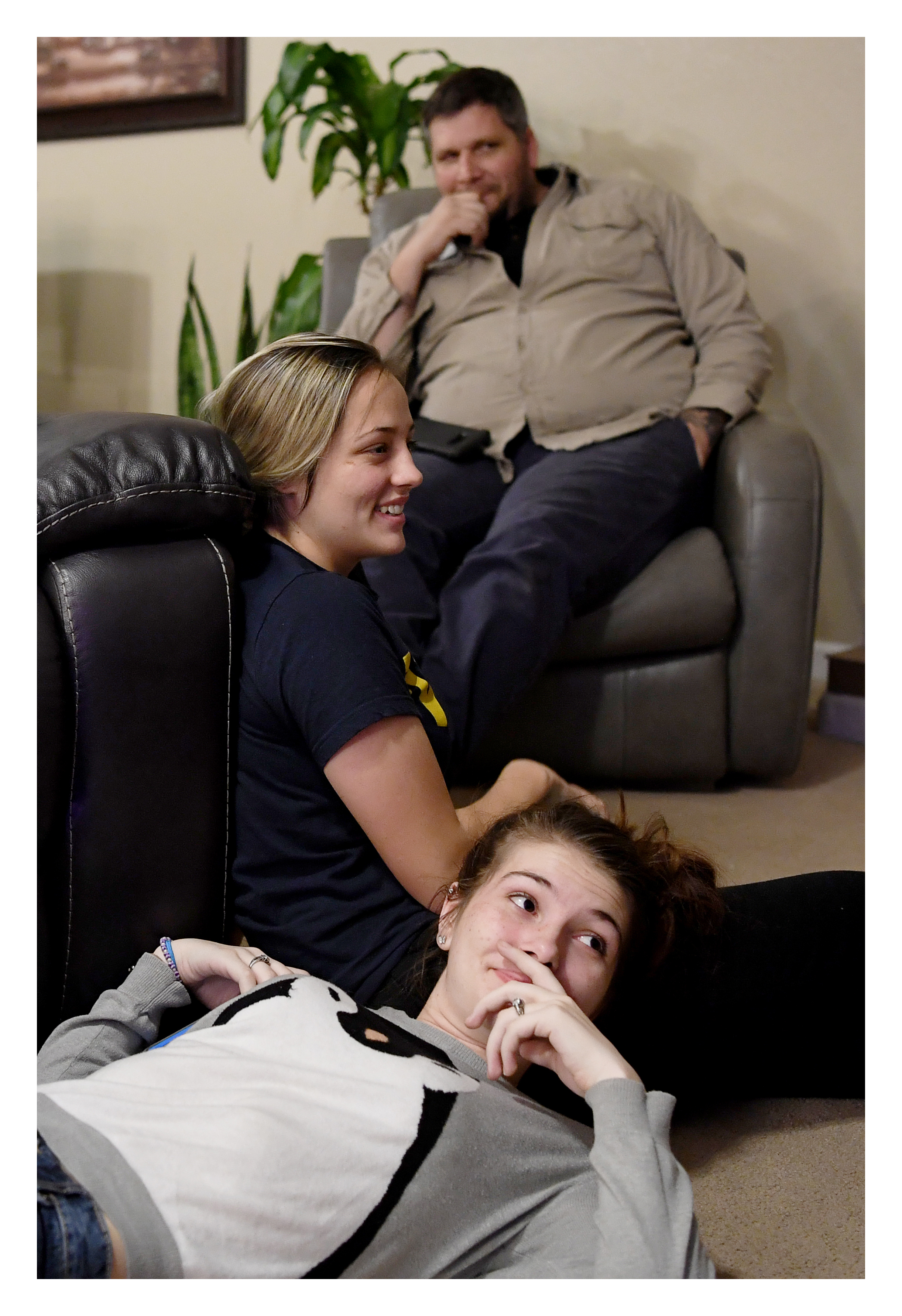 Megan Wyatt, 17, takes a break after decorating the family Christmas tree with her foster sister, Mariah, 18, and her father, Zack, November 30, 2017. 