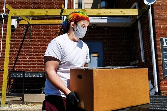 Trace Rudolph, a community intern at Haywood Street Congregation, closes his eyes as the sun is reflected off a food container as he unloads boxes of food donated by Angela and Bryan King of 12 Bones April 4, 2020 in Asheville.
.
.
.
.
.
#haywoodstre