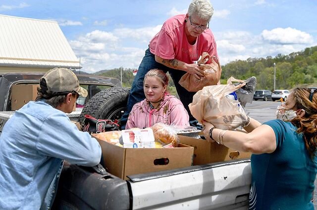 The Norton family, from left, Ray, Rachael, Dee and Judy, make room for food among the passengers in the bed a pickup truck at Beacon of Hope Services in Marshall April 28, 2020. &quot;It's a true blessing, especially in times like these, when everyt