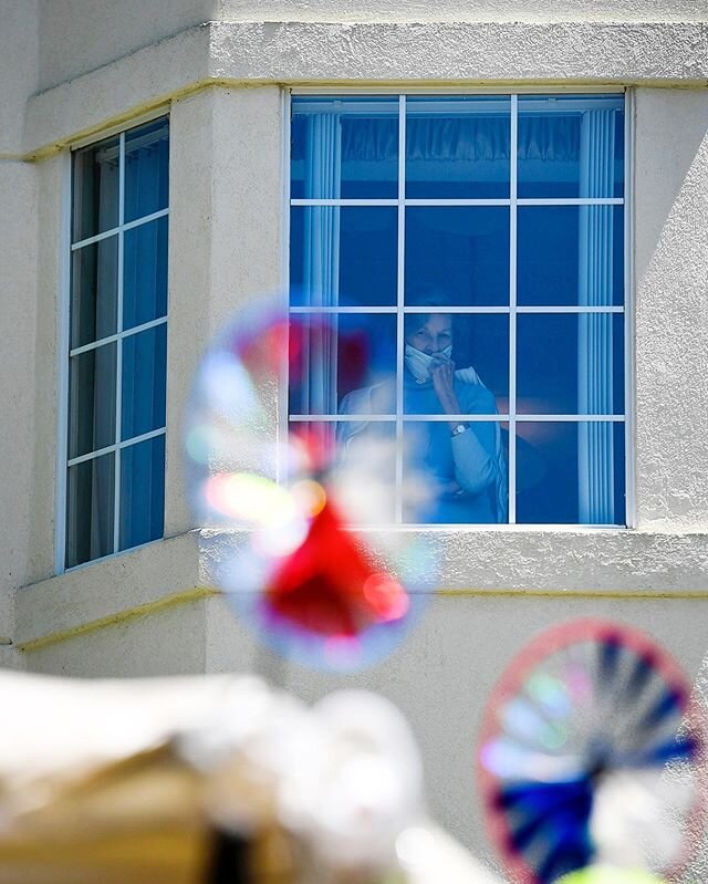 A resident of Lake Pointe Landing watches as staff parade past her window for Mother's Day, May 7, 2020 in Hendersonville.
.
.
.
.
.
#hendersonvillenc #covid19 #mothersday #wnc #northcarolina #ashevillephotographer
