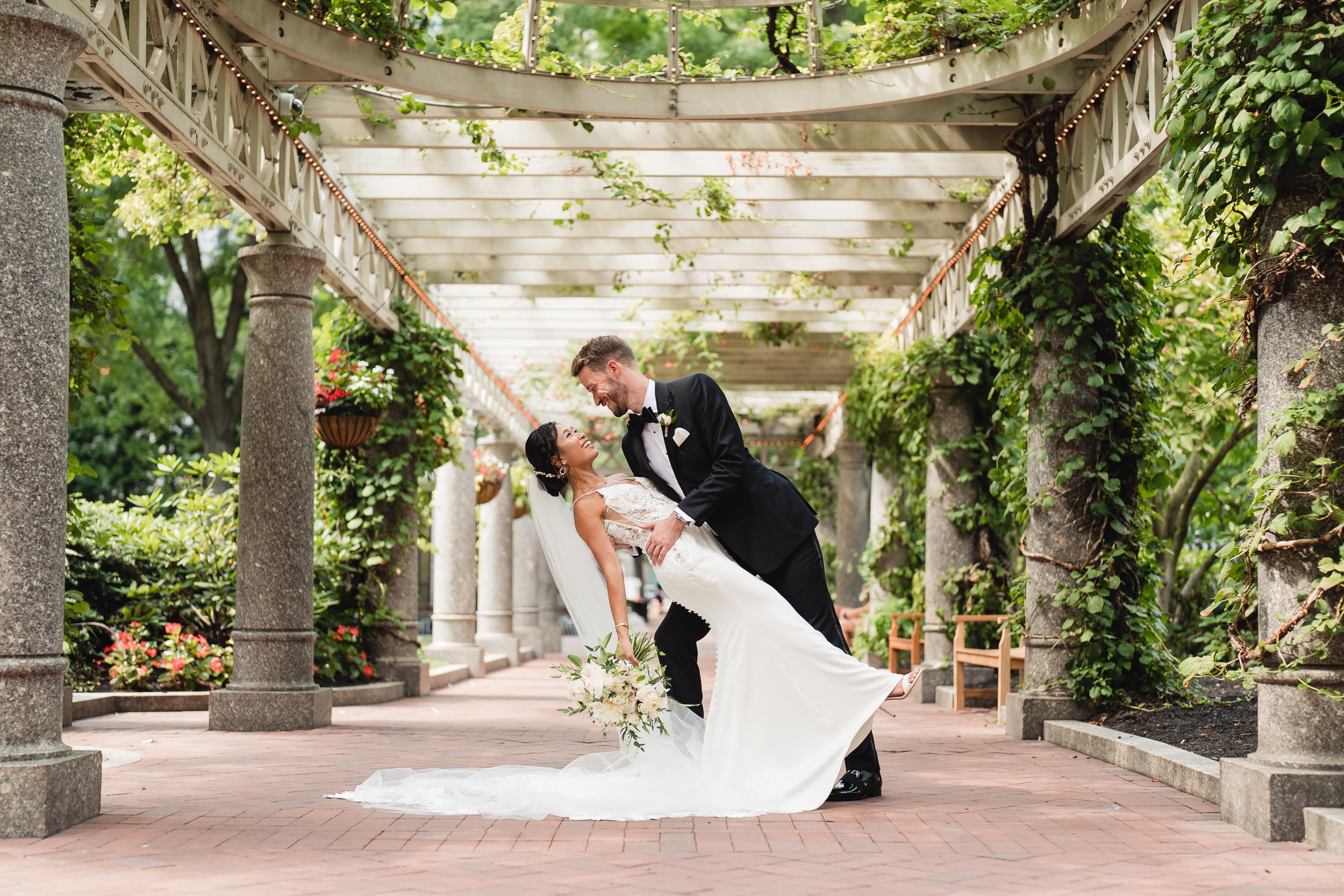 groom dipping bride in post office square