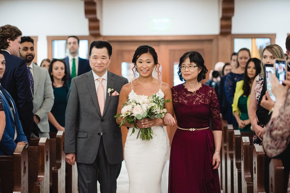 bride walking down aisle at Shrine of Our Lady of Good Voyage