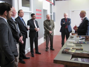 York Guardian Staff photo/DOMINIK KUREK Project Get Reel co-founder Graham Lewis, right, explains to guests how the social enterprise intends to recycle VHS tapes at its facility at the Learning Enrichment Foundation, during a launch event Thursday, April 9, 2015.