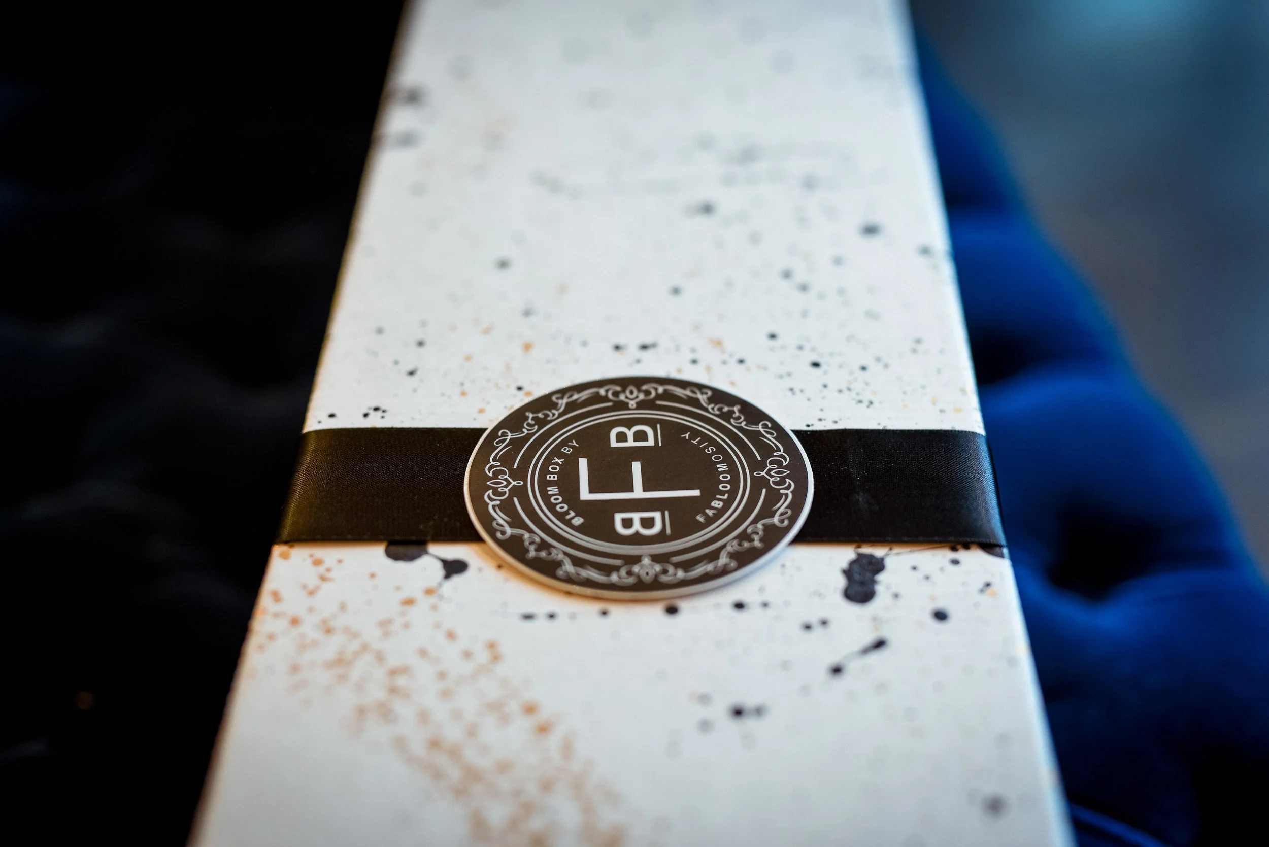 Fabloomosity Classic Rose Box packaging with luxury black ribbon and logo seal, Valentine’s Day flower delivery in Edmonton and St. Albert