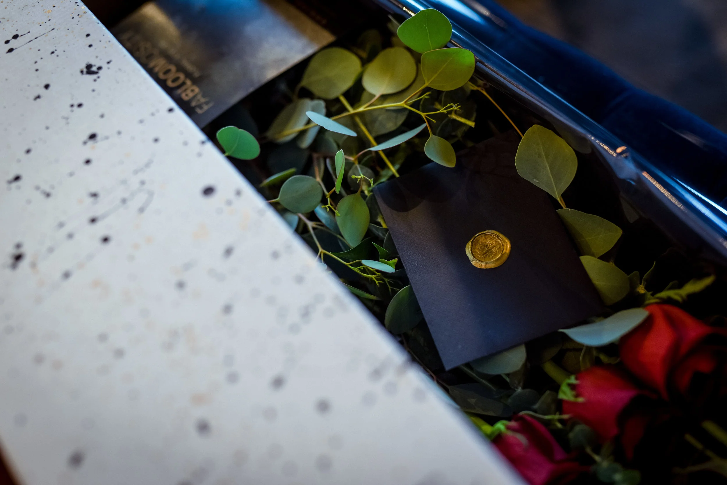 Elegant greenery and branded wax seal inside Fabloomosity Classic Rose Box, upscale Valentine’s floral gift Edmonton