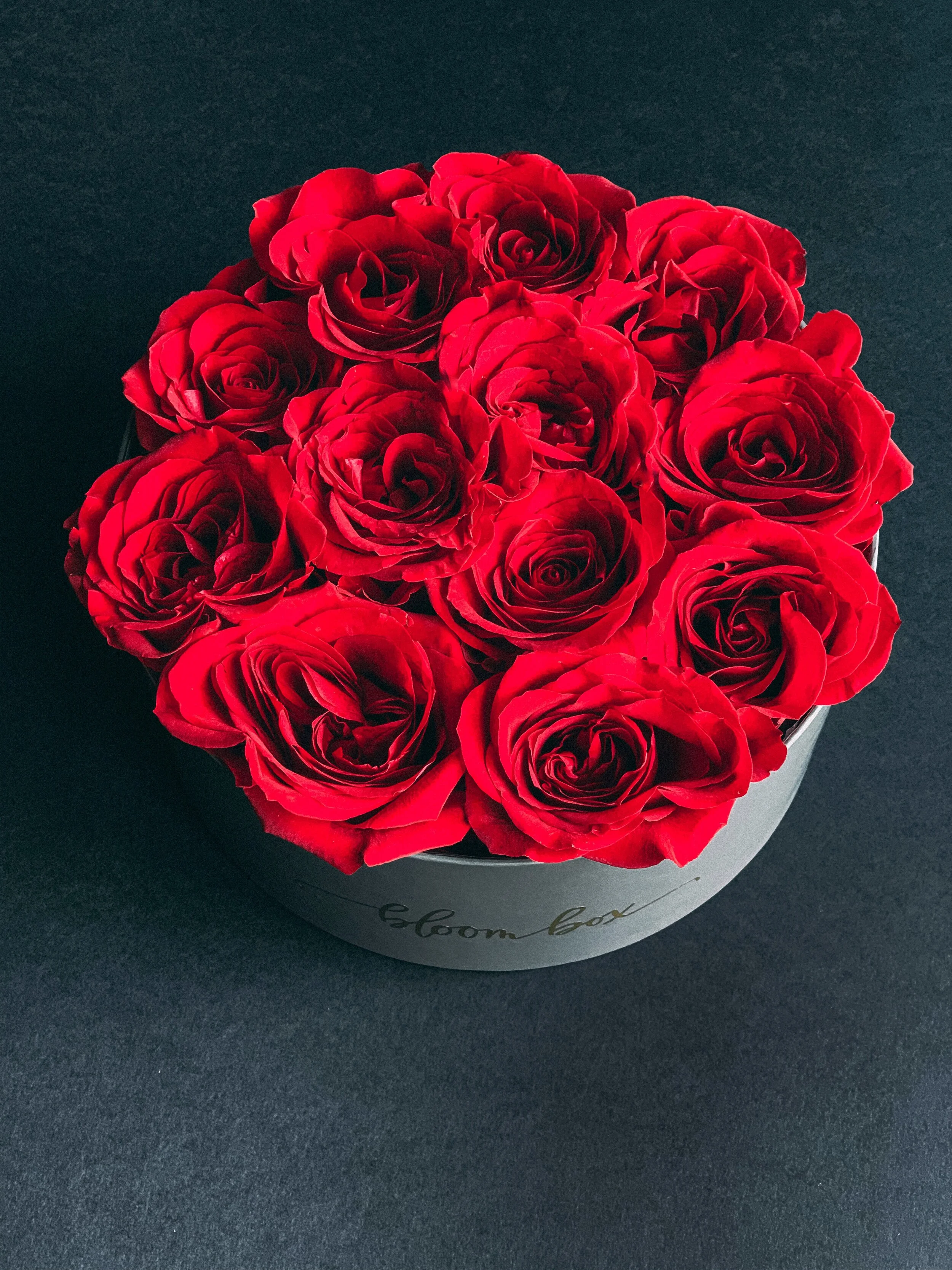Red rose heart box arrangement in a black hat box for Valentine’s Day, available for delivery in Edmonton, St. Albert and surrounding areas.