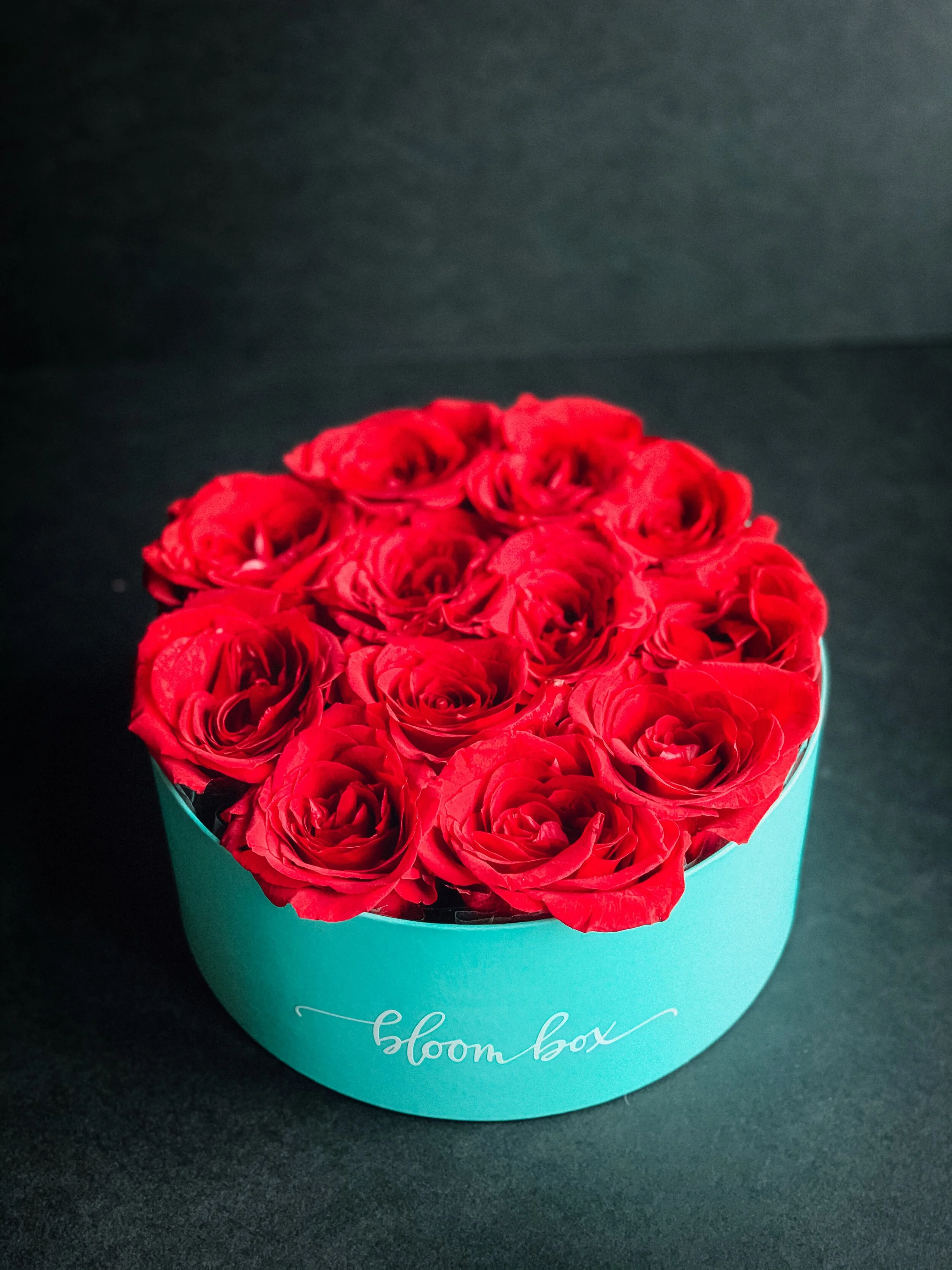 Red rose heart box arrangement in a teal hat box for Valentine’s Day, available for delivery in Edmonton, St. Albert and surrounding areas.