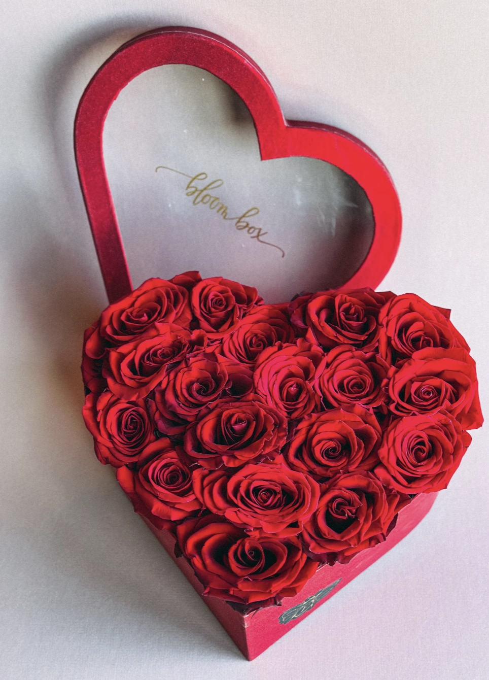 Heart Beat Box featuring red roses arranged inside a red heart-shaped Bloom Box lid