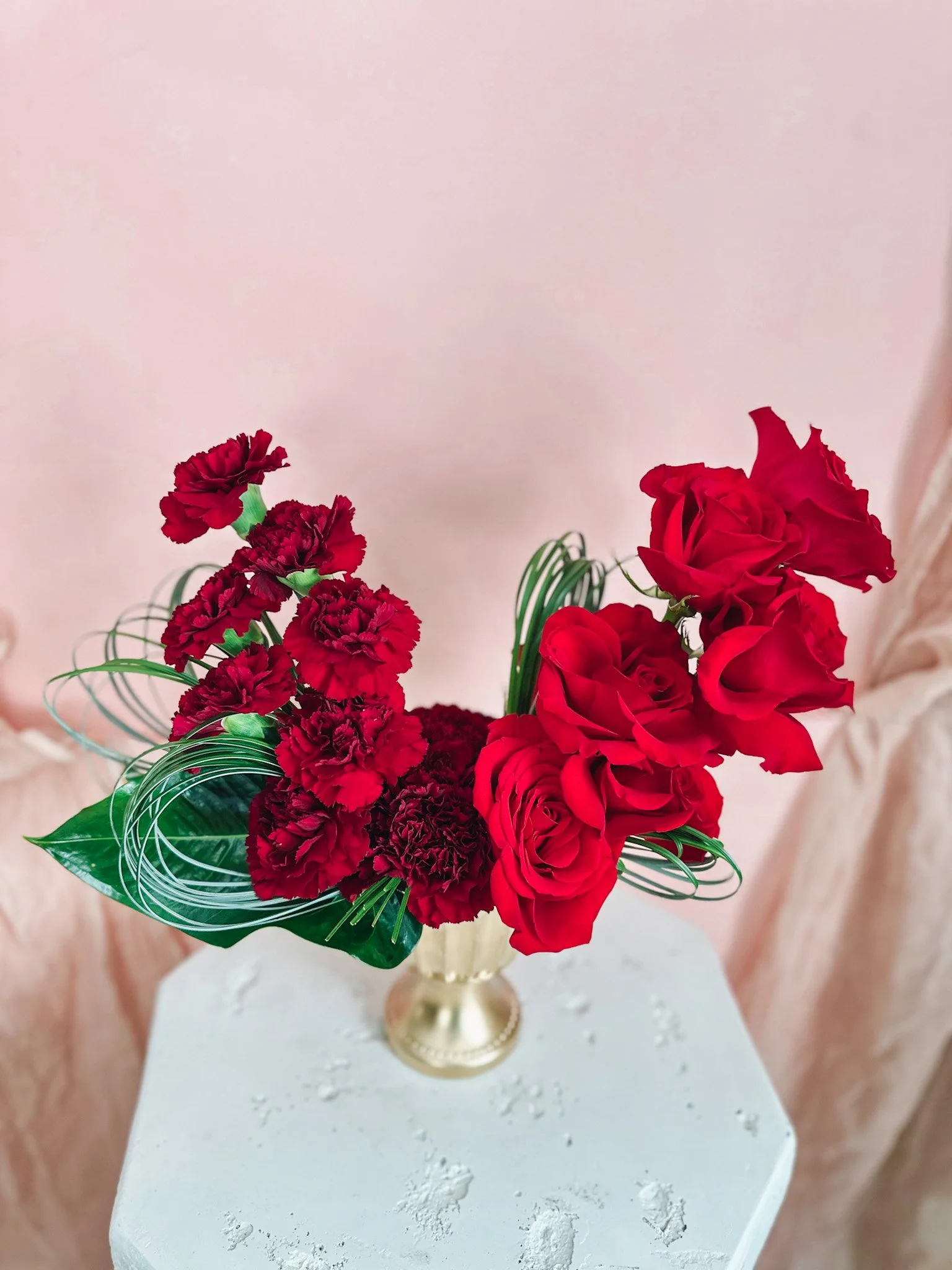 Elegant Valentine’s flower arrangement with red roses and carnations in a gold pedestal vase, The Lover’s Stack in Edmonton and St. Albert