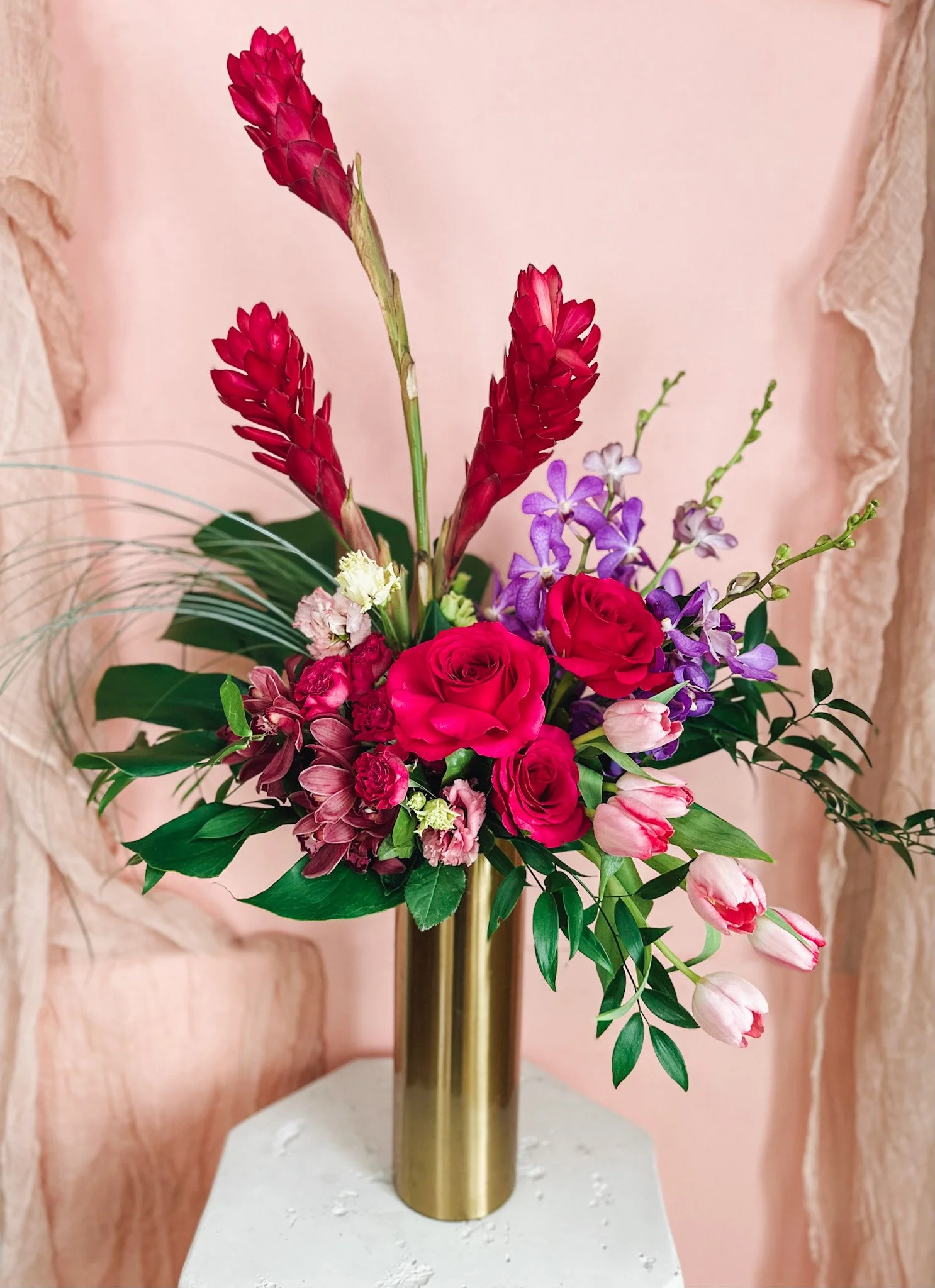 Tall Berry Bliss designer’s choice floral arrangement with red, pink and purple blooms in a gold vase, designed for Edmonton and St. Albert flower delivery.