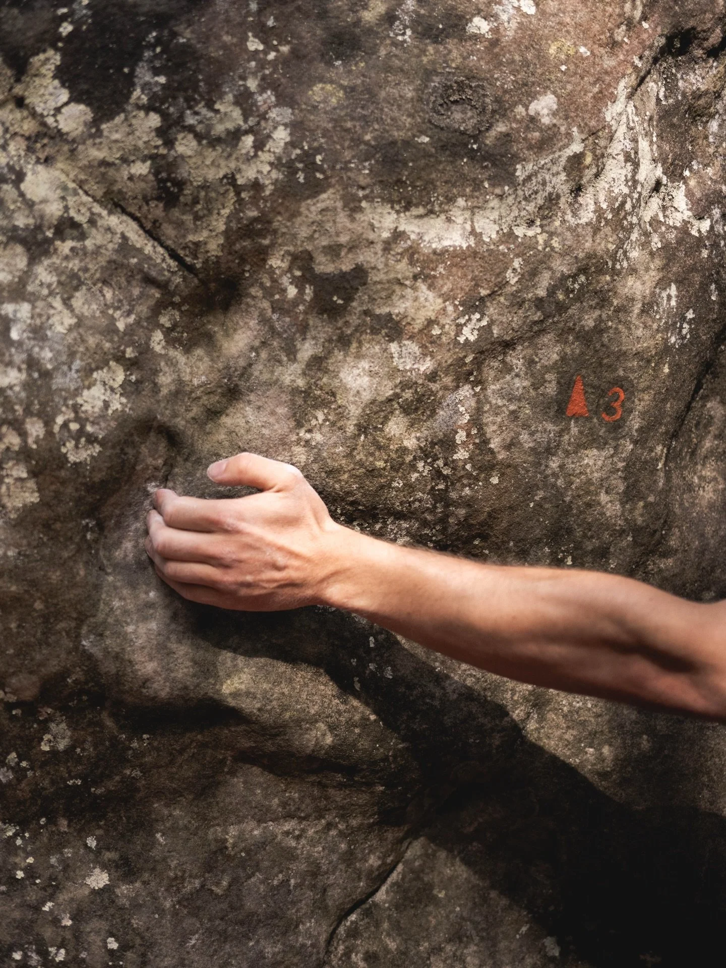 The colours and the numbers on the rock are the route grades and the sequence in a circuit. This is route #3 with a level 4. Looks easy. But it isn&rsquo;t.