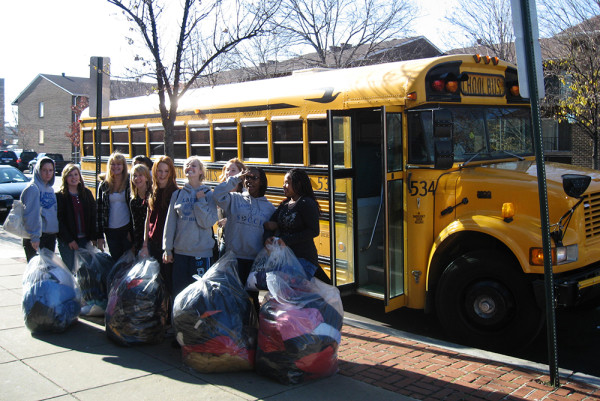 Community members carry bags filled with donations for the clothing program, located at the Southeast D.C. location.