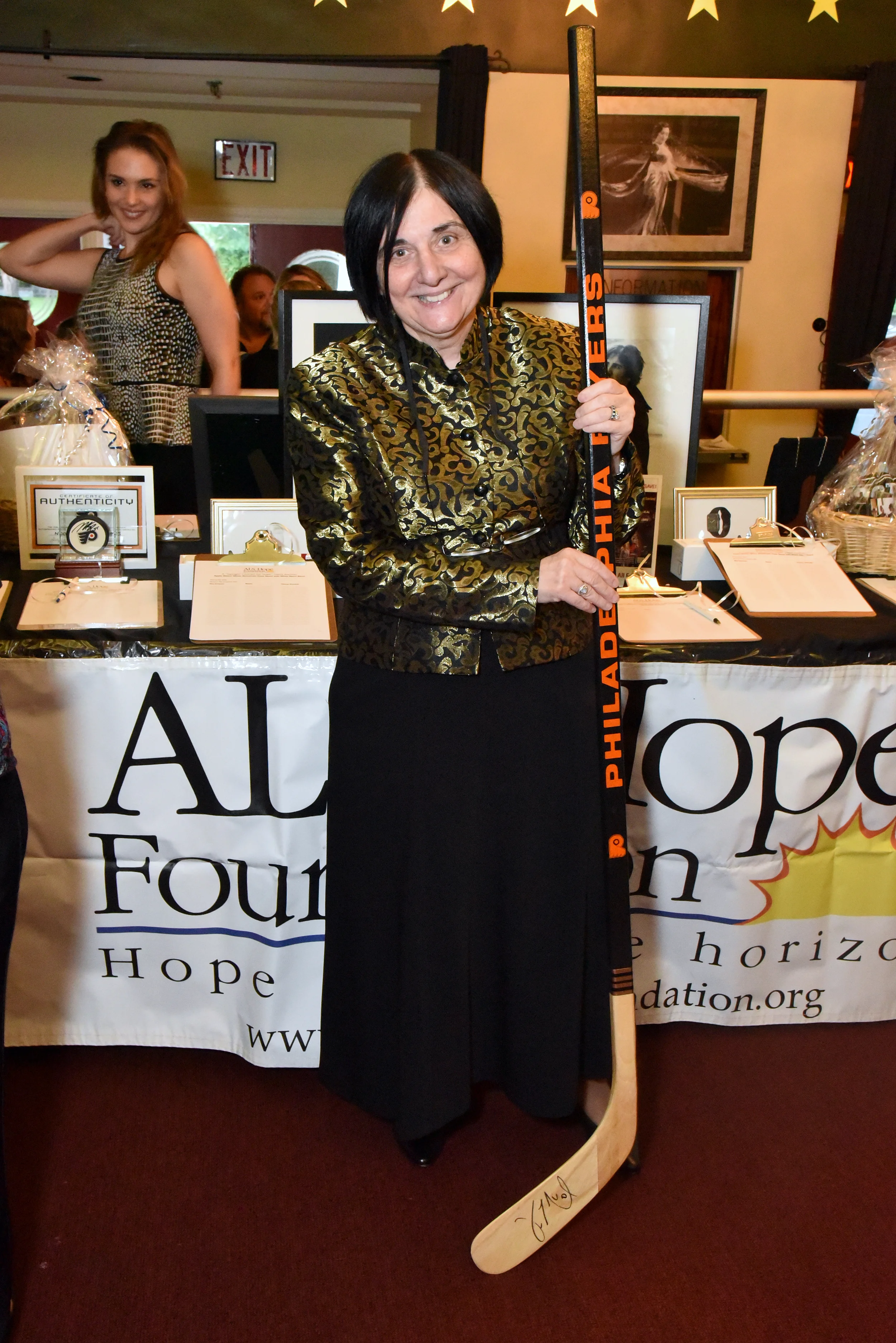 Dr. Terry Heiman-Patterson poses with auction items; photo credit: Robert E. Patterson