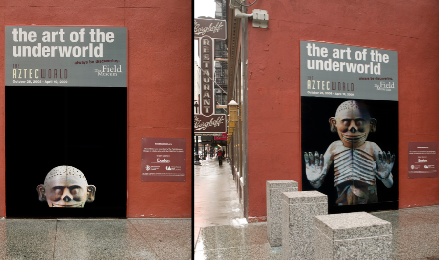 Mictlantecuhtli, the Aztec god of the underworld, appeared to rise from the depths as pedestrians passed.