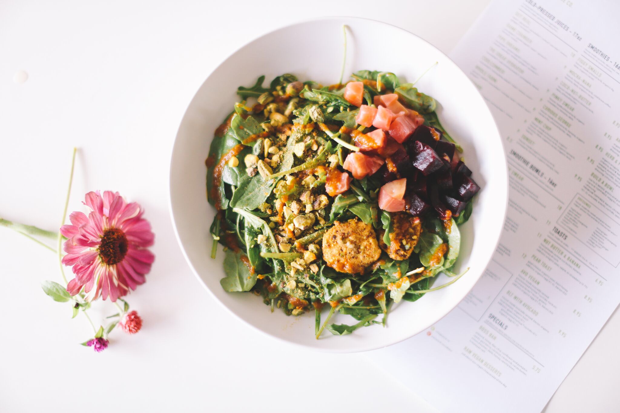 ARUGULA BEET: organic arugula ~ organic spinach ~ roasted organic beets ~ goat cheese ~ pistachio || dressing: roasted carrot vinaigrette || 8.95 * suggested add-ons: avocado, brussel sprouts & bacon