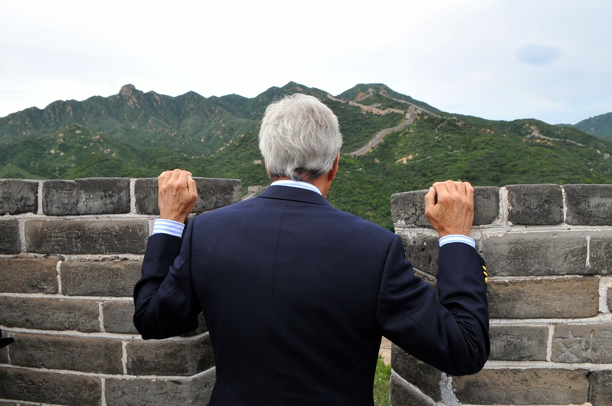  Secretary Kerry peers over a section of the Great Wall at Badalang. 