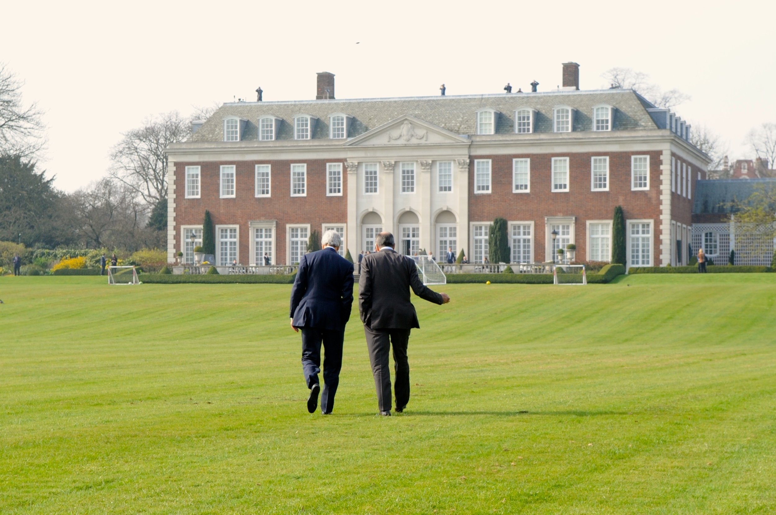  The two diplomats take a walk on the back lawn at Winfield House - the second-largest private yard in London, after the one at Buckingham Palace. 