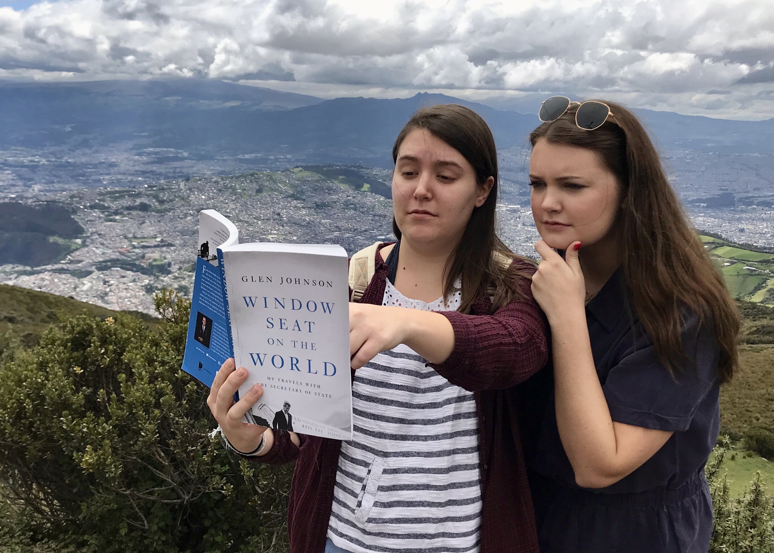  Two of the Coogan Sisters look through the book at 16,000 feet atop a mountain in Quito, Ecuador. 