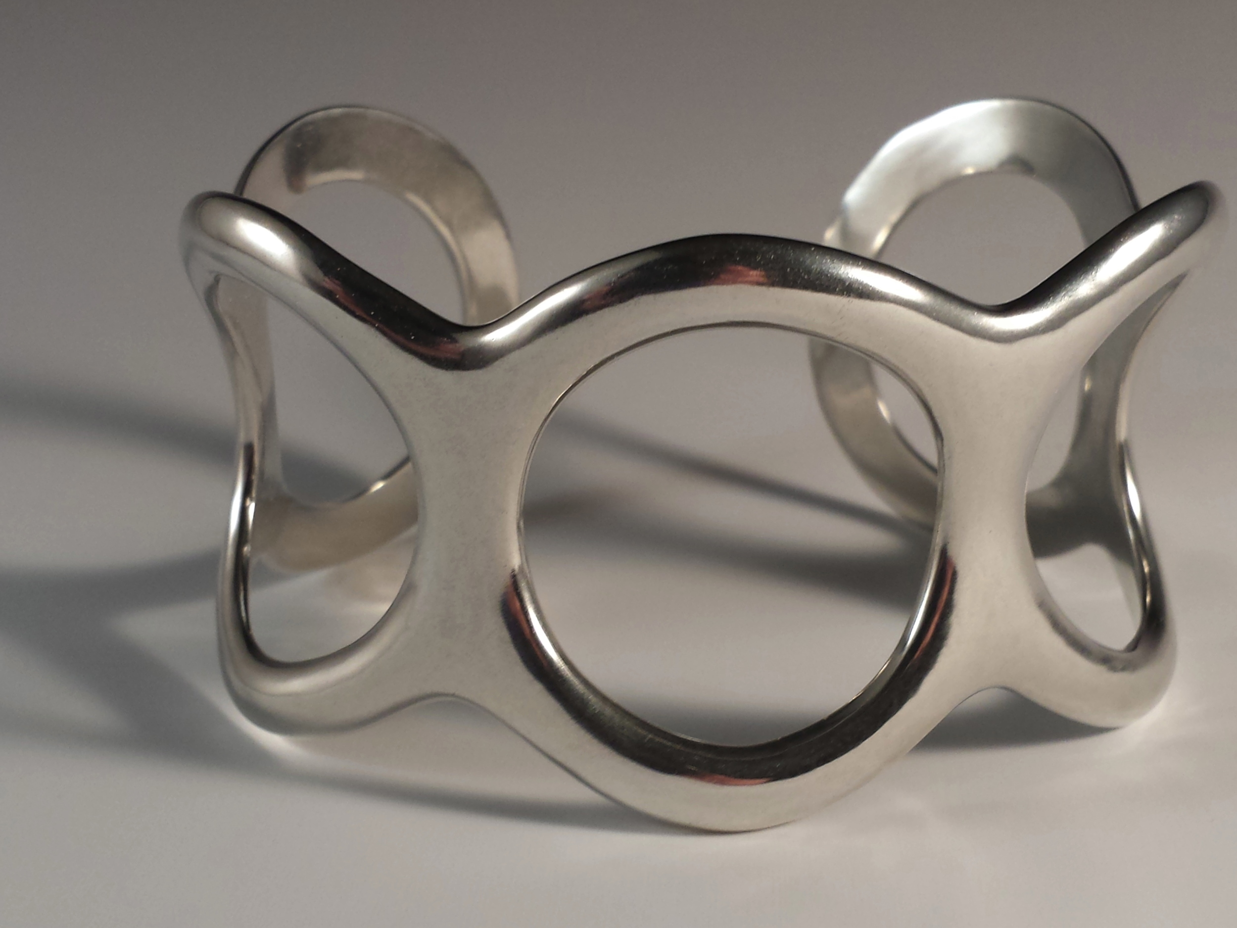 The Circle Cuff was commissioned to recreate a favorite bracelet that was lost but not forgotten. Working from 2 photos Schaefer brought the Circle Cuff Bracelet back to life in shiny, sterling silver. The following are photos showing the process in reverse.
