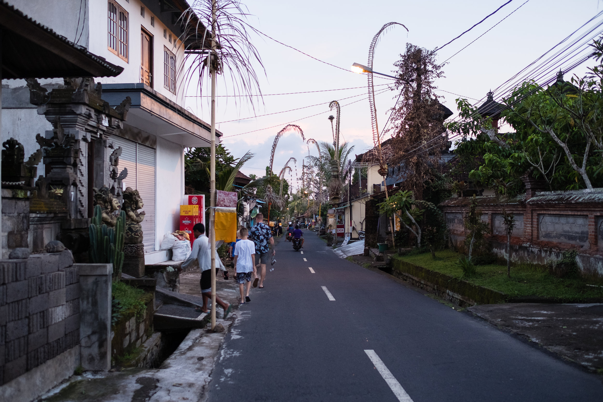 Penjouri from a recent festival hang over the road, each one is handmade by the family from rice.