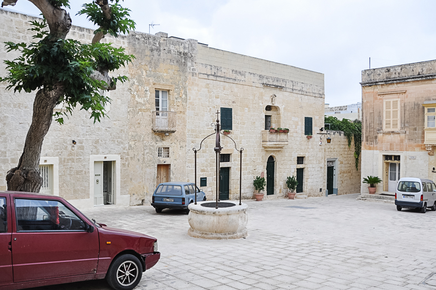 typical plaza of homes in Mdina, note the old well