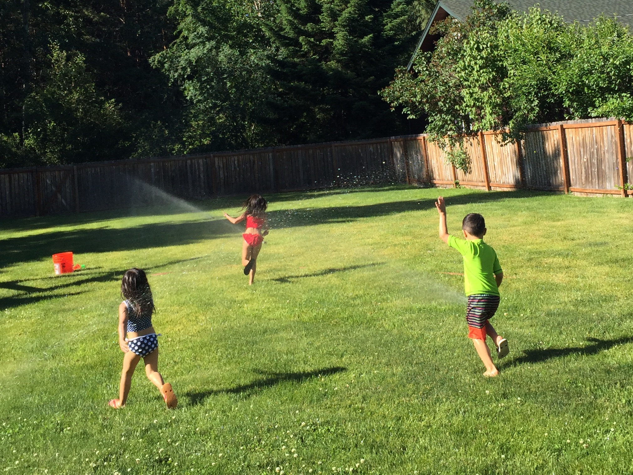It's not summer break without running through the sprinklers