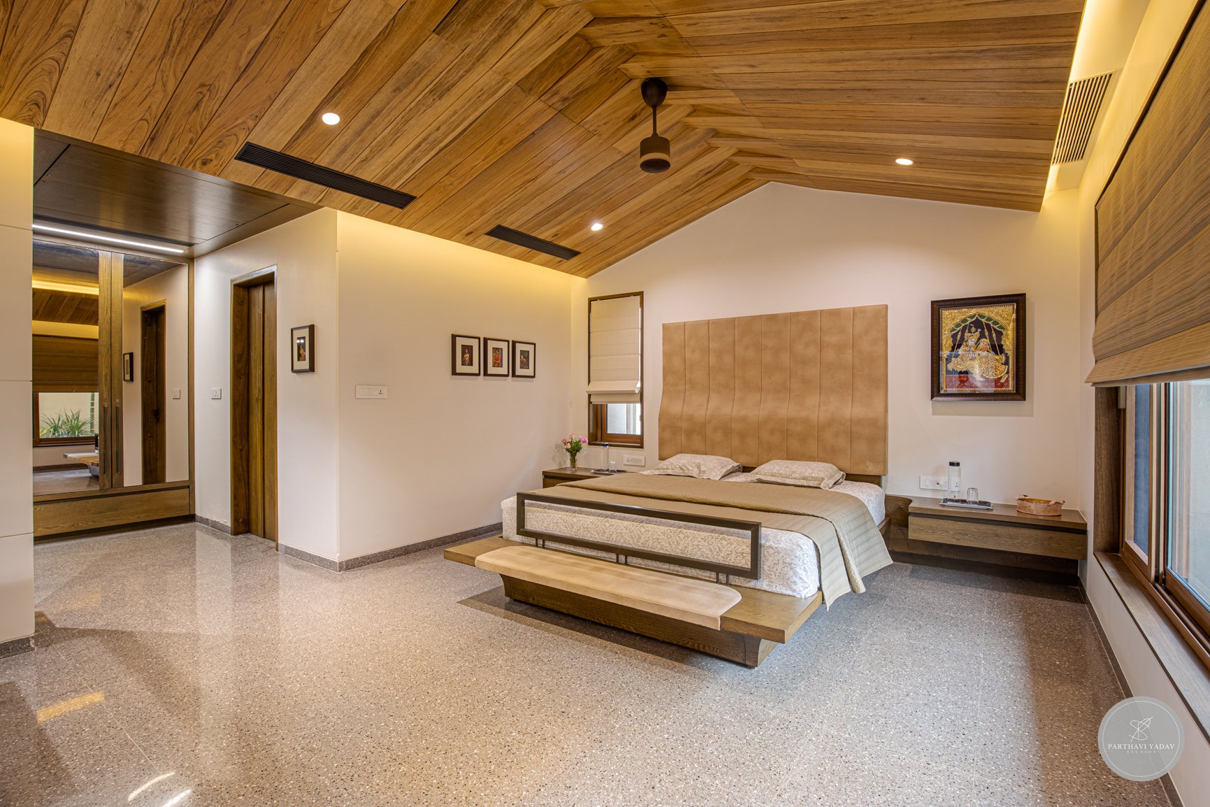 best interior photographer in pune bangalore - master bedroom with leather headrest for a bed with walkin closet and high wooden panel ceiling.jpg