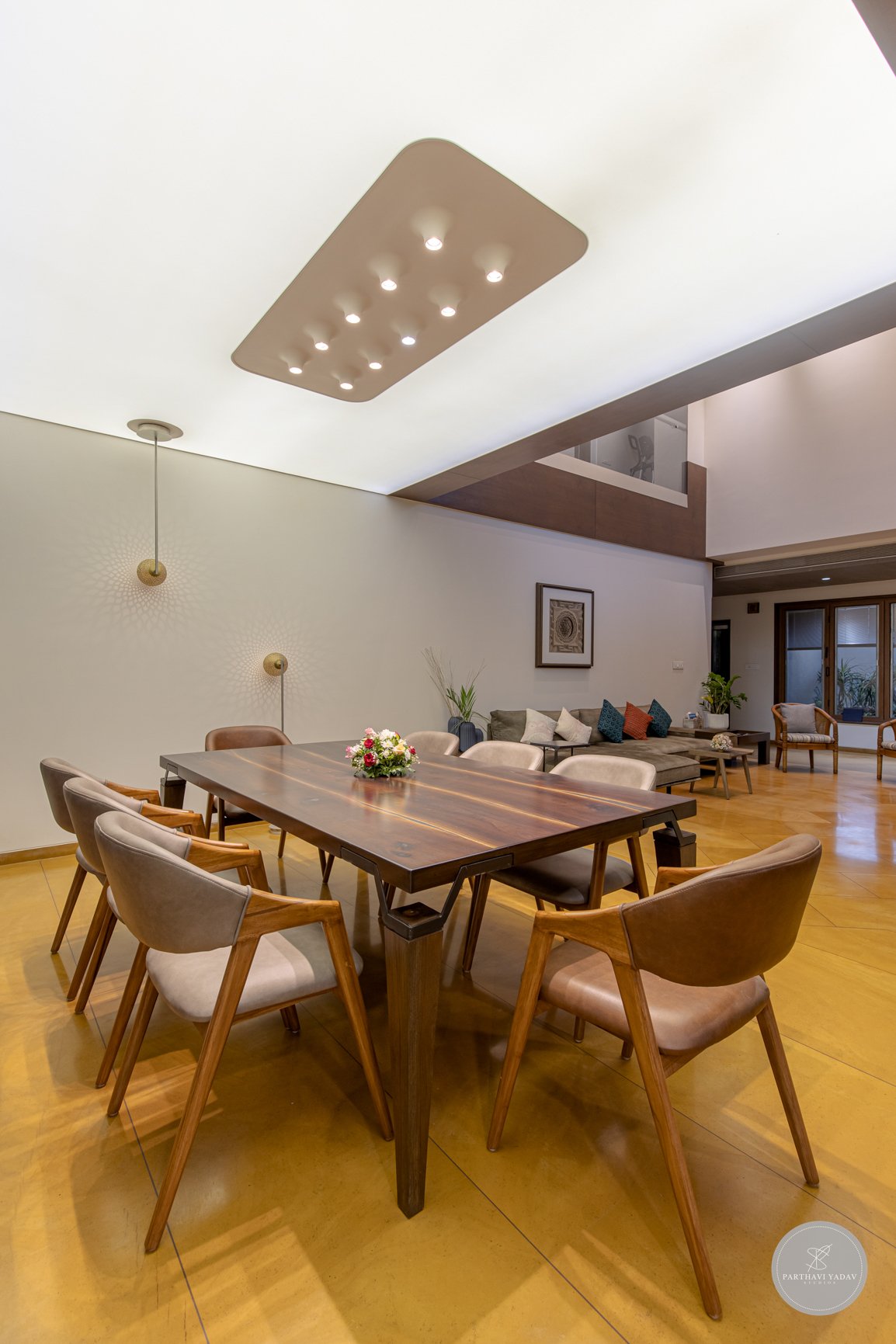 best interior photographer in pune bangalore - custom eight person dining table with the light ceiling and lamps.jpg