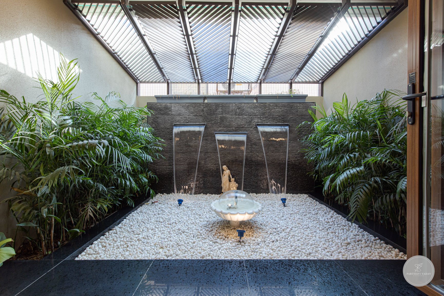 best interior photographer in pune bangalore - indoor fountain with marble statue with greens and sunlight in a bungalow.jpg