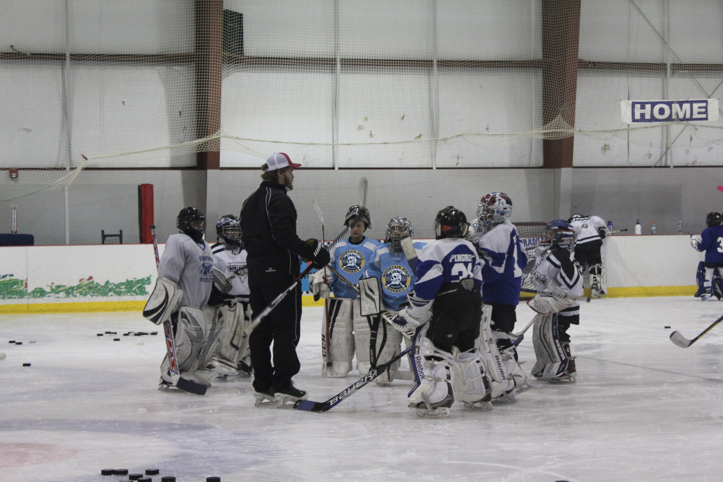 MHH and Denver University Pioneers goalie coach Joe Howe discussing the game plan with the goalies in our Mite and Squirt Group
