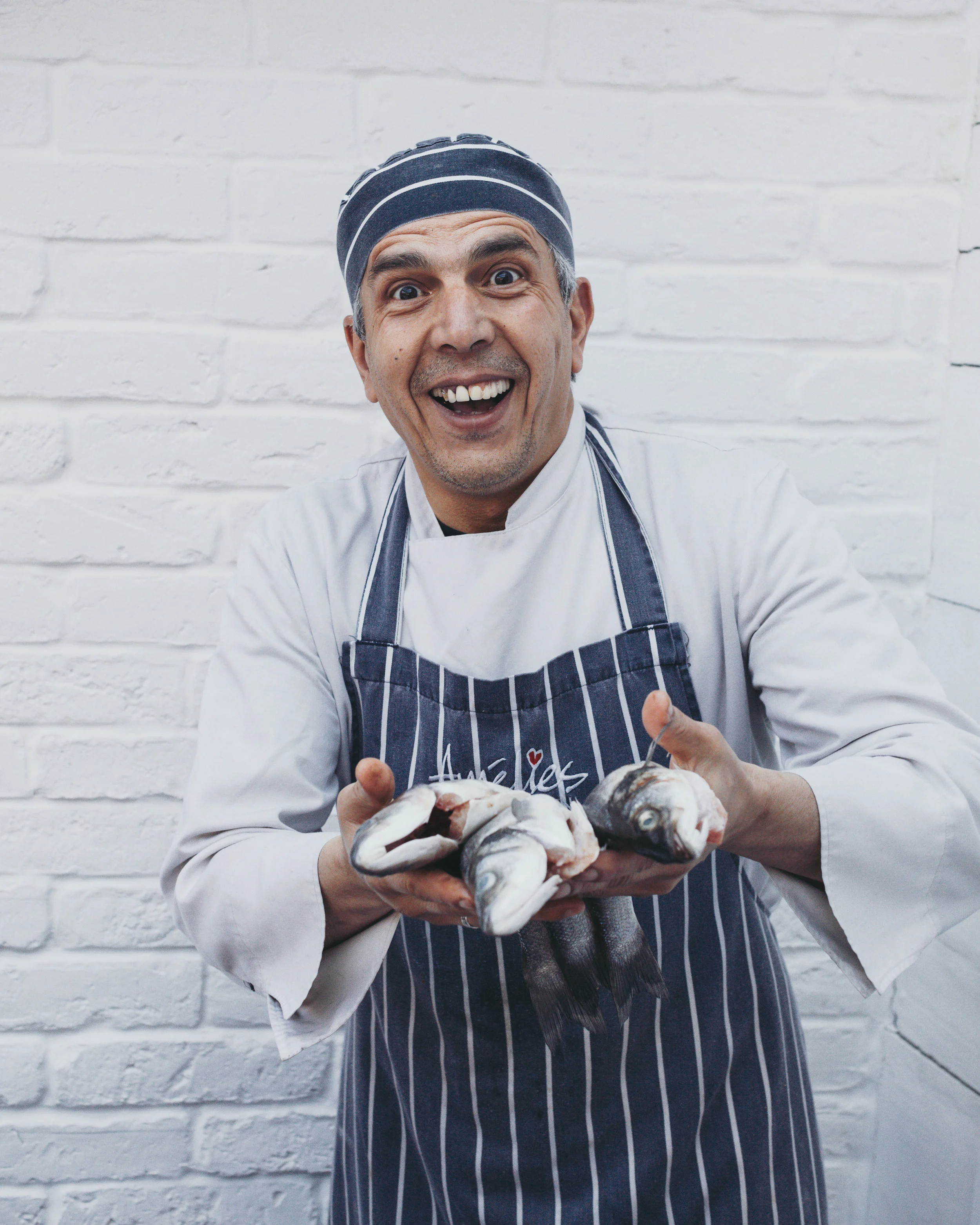 Faydit Food Photography Cornwall Devon Somerset Dorset . Amelies Restaurant Porthleven Chef holding Sea bass