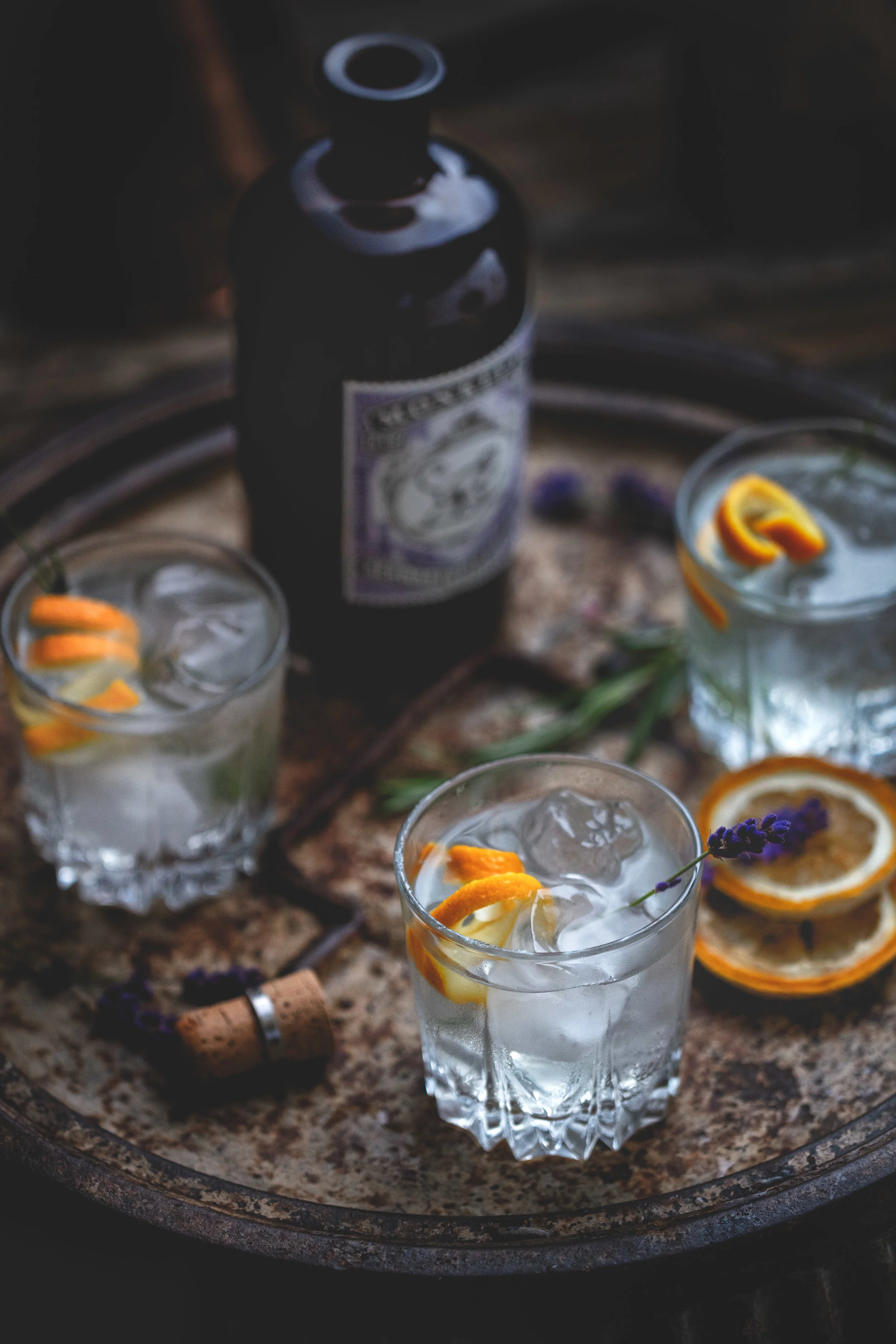 Drink photography of a tray of gin and tonic glasses with Monkey 27 gin bottle in a bar in London shot by Somerset Devon Cornwall based food photographer Faydit Photography