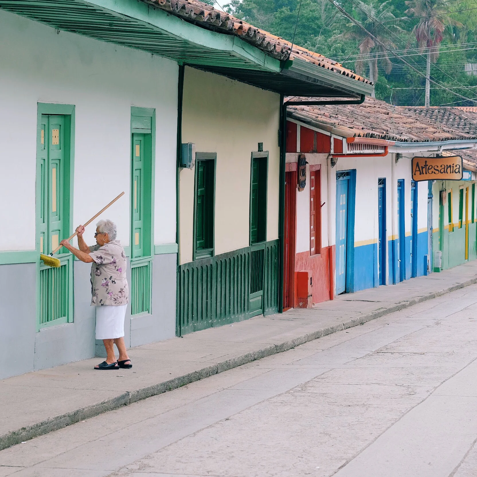 An elderly lady cleaning her house in Salento .