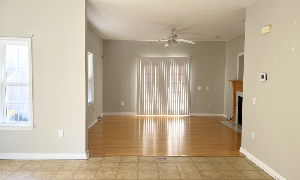 •	Living room before staging with mismatched flooring and dated ceiling fan, Howard County MD home